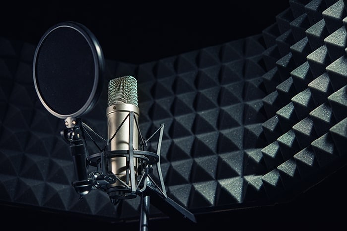 Soft furnishings on the wall affect the reflective properties of sound within a recording studio.